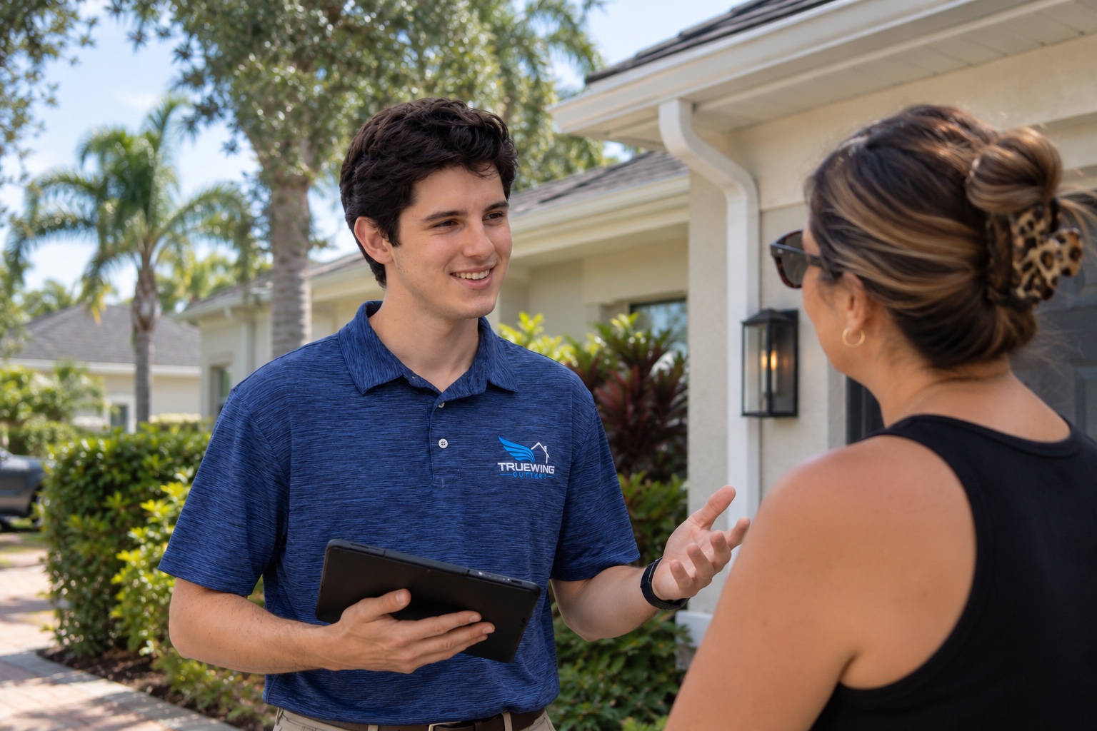 Mathias from TrueWing Gutters speaking with a homeowner about her gutter project