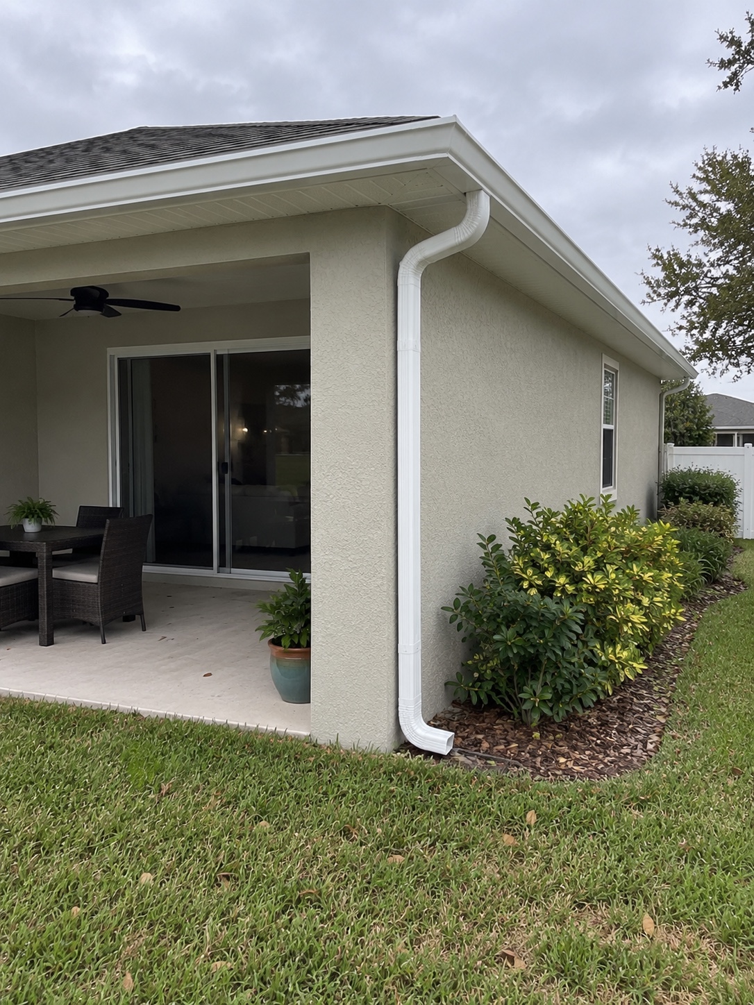 Windermere patio with white gutters and a corner downspout